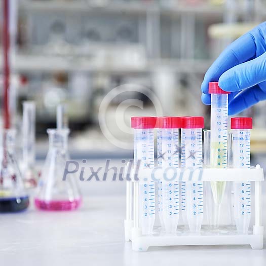Hand lifting a test tube Hand lifting a test tube