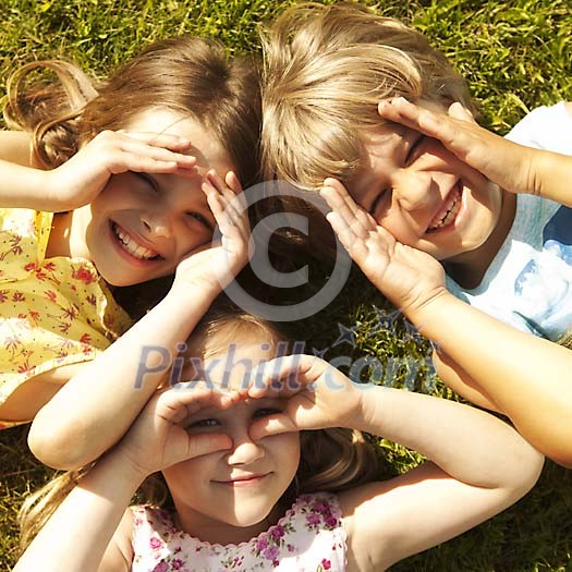 Children covering their eyes from sun Children covering their eyes from sun