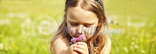 Girl smelling summer flowers Girl smelling summer flowers