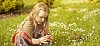 Girl picking flowers on the meadow