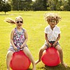 Boy and a girl jumping on the rubber balls