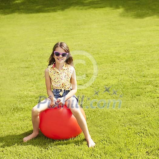 Girl sitting on a rubber ball Girl sitting on a rubber ball