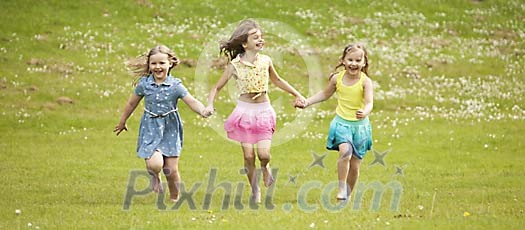 Three girls running on the meadow Three girls running on the meadow