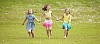 Three girls running on the meadow