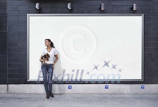 Woman standing in front of a blank poster Woman standing in front of a blank poster