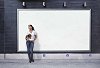 Woman standing in front of a blank poster