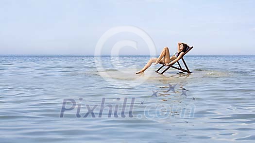 Woman sunbathing on a small island Woman sunbathing on a small island