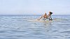 Woman sunbathing on a small island