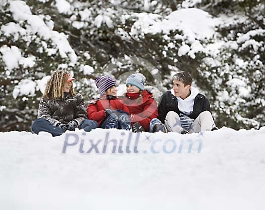 Teenagers sitting in the snow Teenagers sitting in the snow