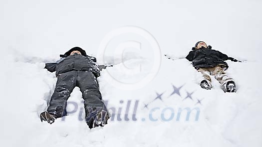 Two people making snow angels Two people making snow angels
