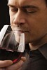 Man smelling red wine