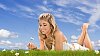 Woman on the grass enjoying daisies