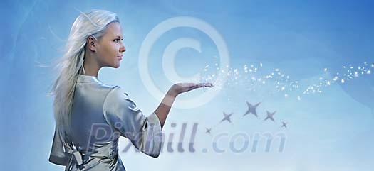 Blonde girl sending magical dust from her palm Blonde girl sending magical dust from her palm
