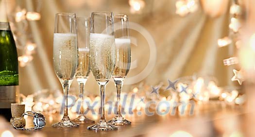 Panorama shaped background with champagne glasses and glittering lights Panorama shaped background with champagne glasses and glittering lights