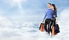 Young happy couple walkin in clouds with many shopping bags