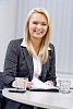 Young business woman behind a meeting table