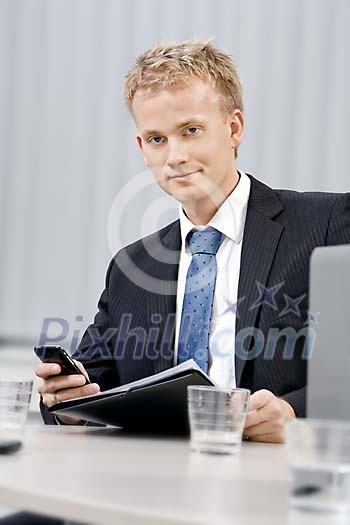 Young business man behind his desk Young business man behind his desk