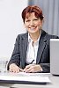 Smiling business woman behind her desk