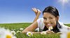 Beautiful girl lying in grass surrounded by daisies