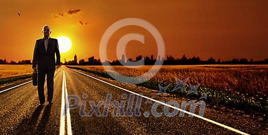 Older businessman walking away from a city in a sunset Older businessman walking away from a city in a sunset