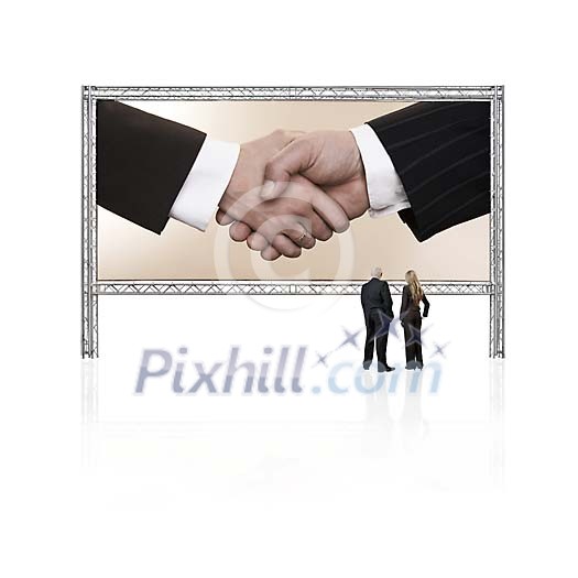 Two business persons in front of a giant display with shaking hands Two business persons in front of a giant display with shaking hands