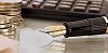 Shallow focus close-up of pen, coins and keyboard on a table