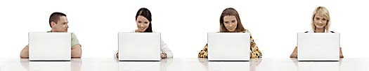 Four persons behind laptops in white space Four persons behind laptops in white space