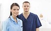 Two nurses and patient in a light hospital room