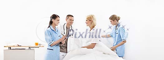 Light hospital room with friendly staff and happy patient Light hospital room with friendly staff and happy patient