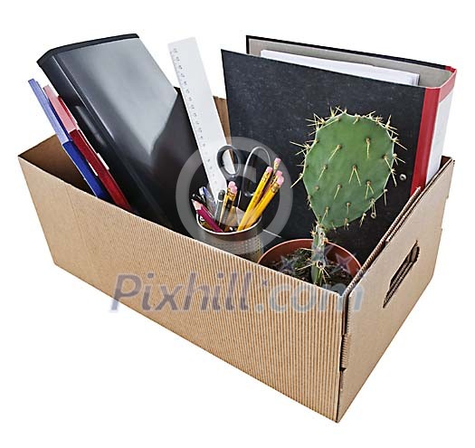 Office desk items in cardboard box Office desk items in cardboard box
