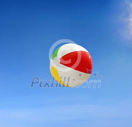 Beach ball flying against blue sky Beach ball flying against blue sky