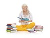 Girl sitting on floor surrounded by piles of books
