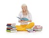 Girl sitting on floor surrounded by piles of books