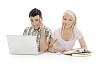 Teenage boy and girl behind study books and laptop