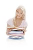 Girl behind a pile of books isolated on white