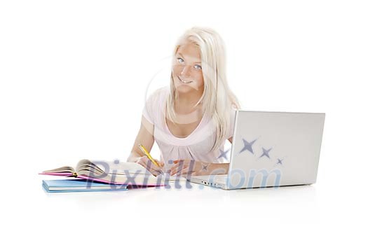 Teenage girl behind study books and laptop Teenage girl behind study books and laptop