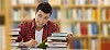 Teenager boy studying in library