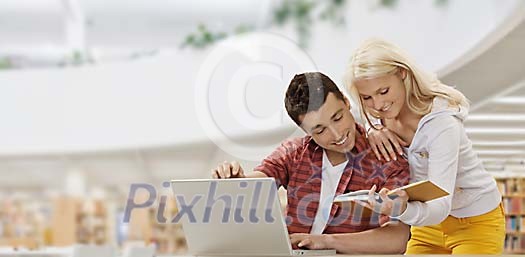 Teenagers studying in a modern library Teenagers studying in a modern library