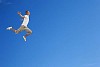 Man jumping against a blue sky