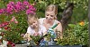 Mother and daughter working together in a sunny garden