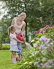 Mother and daughter watering flowers together