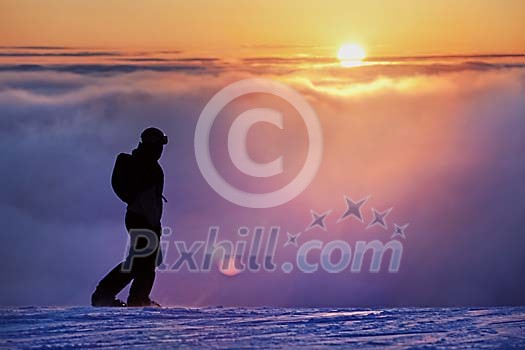 Snowboarder in a sunset Snowboarder in a sunset