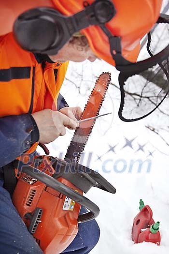 Man sharpening chainsaw Man sharpening chainsaw