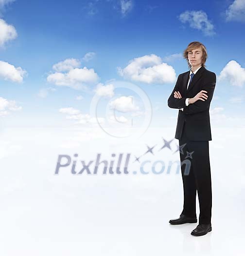 Young businessman standing under the sky with copyspace