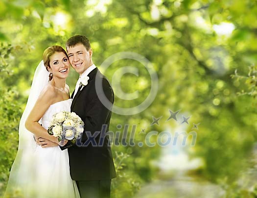 Couple standing under the trees Couple standing under the trees