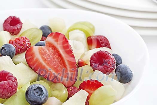 Bowl with different fruits and berries for breakfast