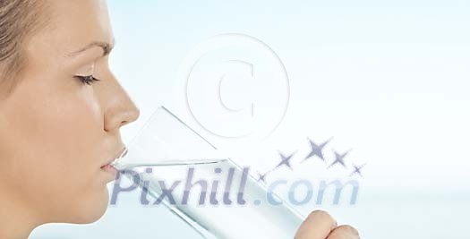 Woman taking a sip of water Woman taking a sip of water