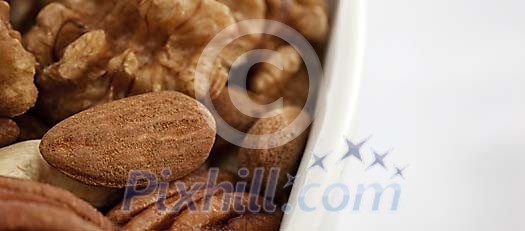 Different nuts in a white bowl Different nuts in a white bowl