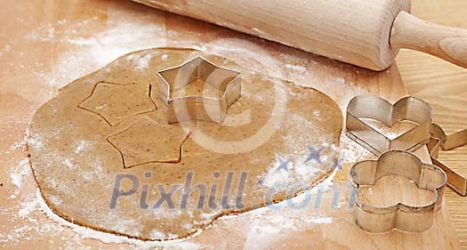 Gingerbread dough with moulds and rolling pin Gingerbread dough with moulds and rolling pin