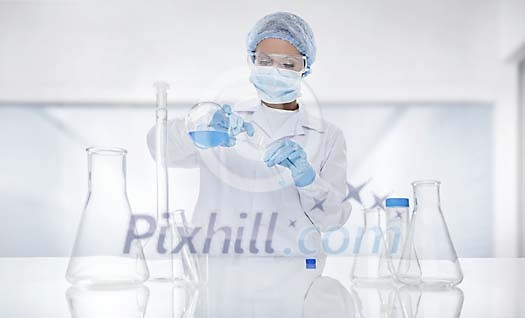 Laboratory assistant pouring fluid to a test tube